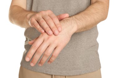 Man applying cream onto hand against white background, closeup