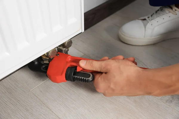 Professional Plumber Using Adjustable Wrench Installing New Heating Radiator Indoors — Stock Photo, Image