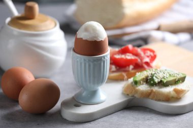 Kahvaltıda açık gri masada servis edilen lezzetli haşlanmış tavuk yumurtası.