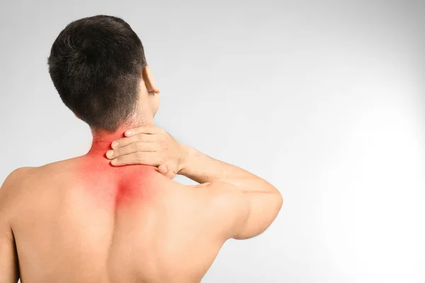 Young Man Suffering Neck Pain Light Background — Stock Photo, Image