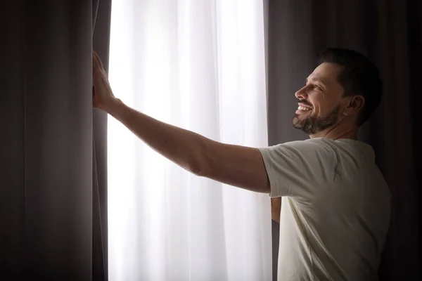 Happy Man Opening Window Curtains Home — Stock Photo, Image