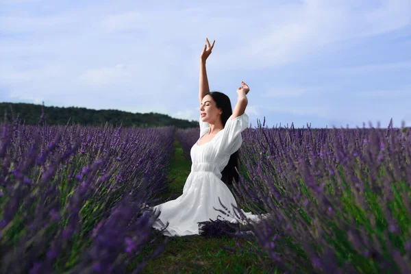 stock image Beautiful young woman sitting in lavender field