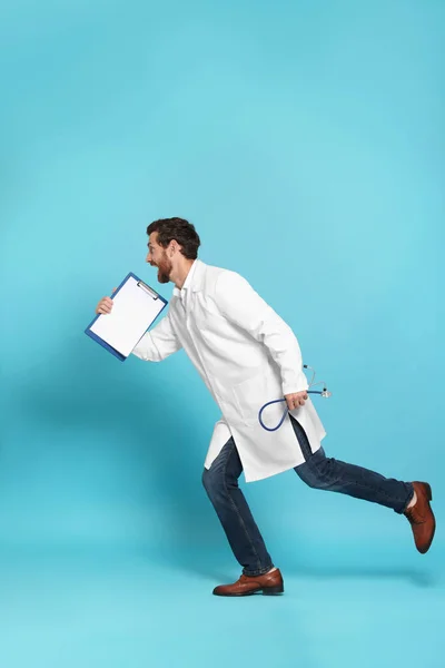 Doctor with stethoscope and clipboard running on light blue background