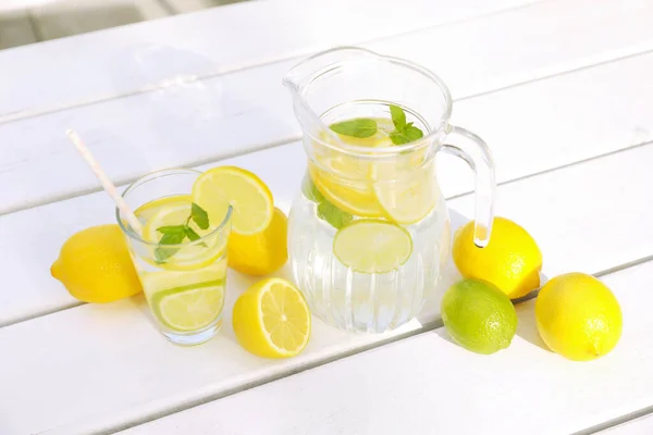 Water Lemons Limes White Wooden Table Outdoors — Stock Photo, Image