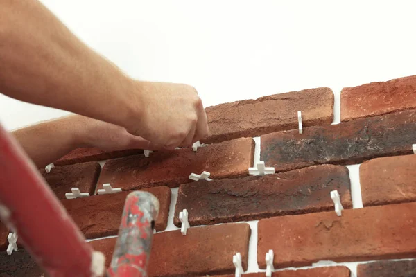 stock image Professional builder gluing decorative brick on wall, closeup. Tiles installation process