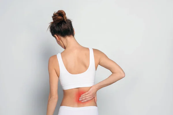 Mujer Que Sufre Dolor Espalda Sobre Fondo Gris Claro —  Fotos de Stock