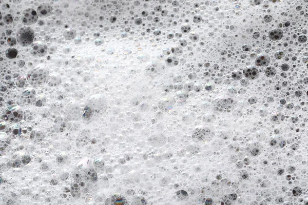 濃い灰色の背景に白い泡を洗う トップビュー — ストック写真