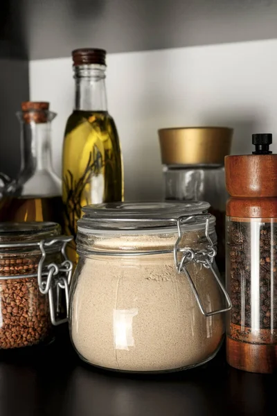 Glass jar of buckwheat flour on shelf