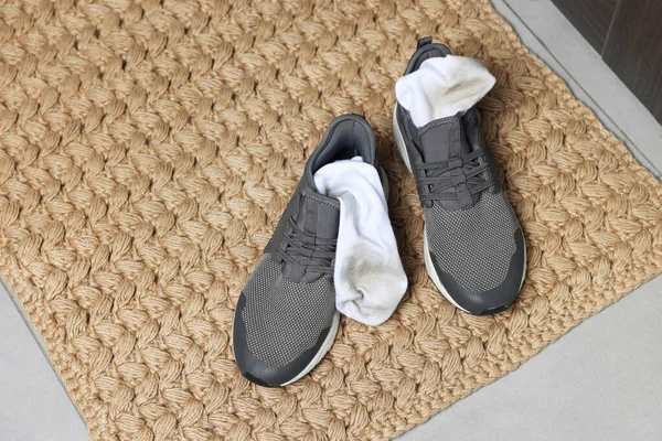 Sneakers Dirty Socks Woven Mat Indoors Closeup Space Text — Stock Photo, Image