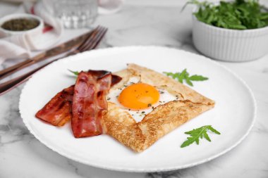 Delicious crepe with egg served on white marble table. Breton galette clipart