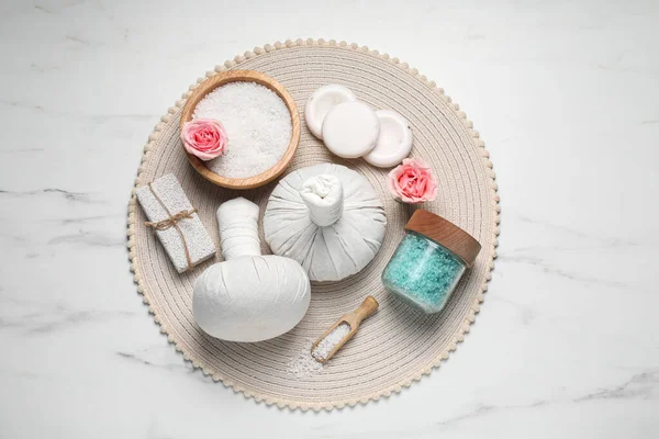 stock image Herbal bags and spa products on white marble table, top view