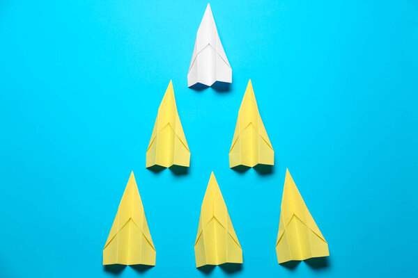Flat lay composition with paper planes on light blue background