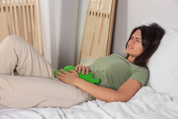 Young Woman Using Hot Water Bottle Relieve Cystitis Pain Bed — Stock Photo, Image