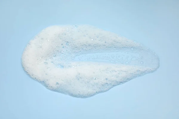 Smudge White Washing Foam Light Blue Background Top View — Stock Photo, Image