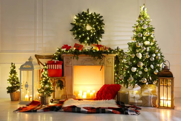 Beautiful Christmas themed photo zone with fireplace and fir decor