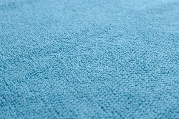 Dry soft blue towel as background, closeup