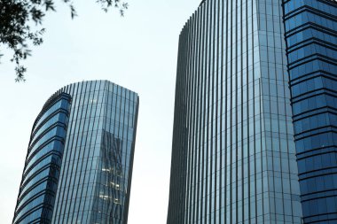 Gökyüzüne karşı birçok penceresi olan modern binaların düşük açılı görüntüsü