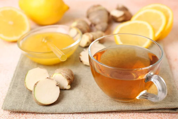 Tea, honey, lemon and ginger on table, closeup