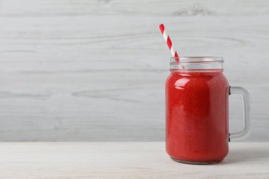 Mason kavanozu ve beyaz ahşap masada lezzetli meyve püresi. Metin için boşluk