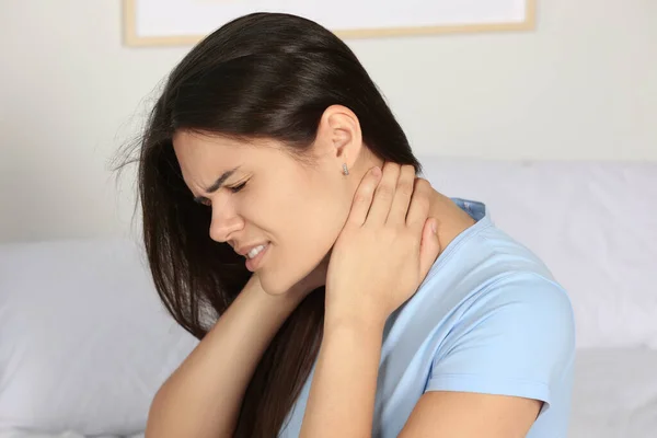 Young Woman Suffering Neck Pain Indoors — Stock Photo, Image