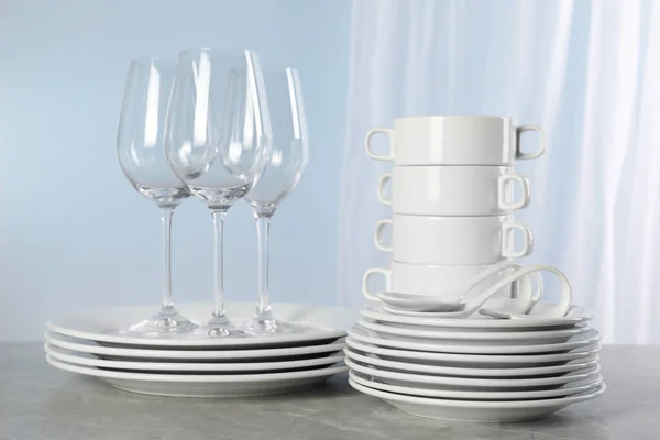 Set Clean Dishware Glasses Grey Marble Table — Stock Photo, Image