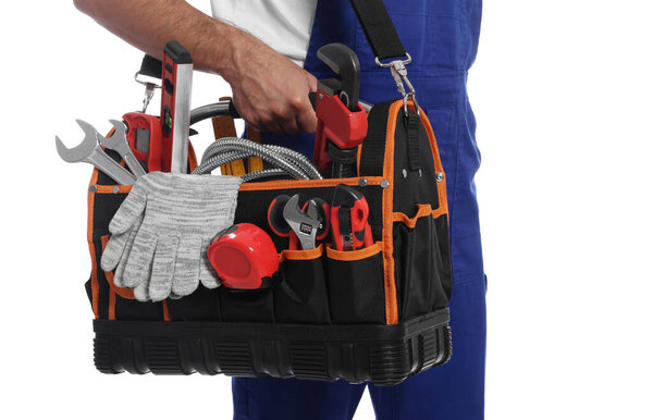 Professional plumber with tool bag on white background, closeup