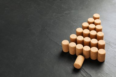 Karanlık taş arka planda şarap mantarlarından yapılmış Noel ağacı. Metin için boşluk