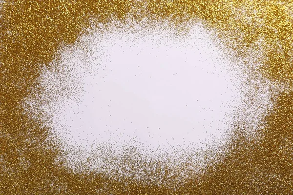 Frame made of shiny golden glitter on white background, top view