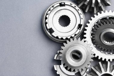 Gri arka planda pek çok paslanmaz çelik dişli düz zemin. Metin için boşluk