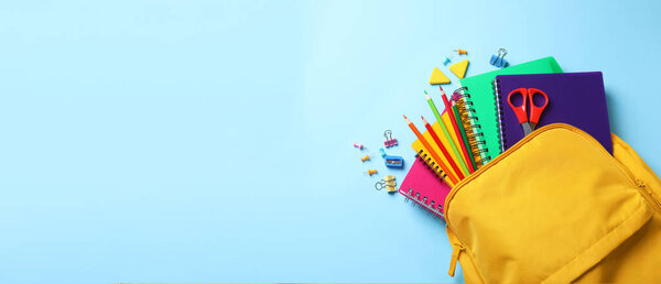 Flat lay composition with backpack, school stationery on light blue background, space for text. Banner design