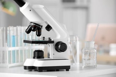 Modern medical microscope on white table in laboratory