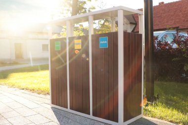 Güneşli bir günde atık geri dönüşümü için farklı çöp kutuları.