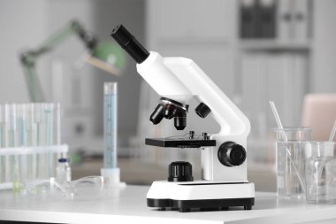 Modern medical microscope on white table in laboratory