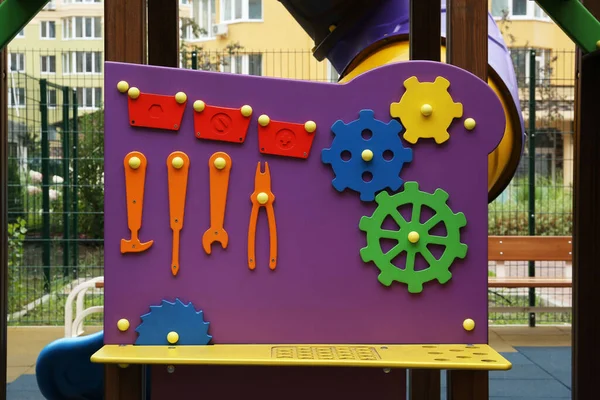 Colourful busy board on outdoor playground in residential area
