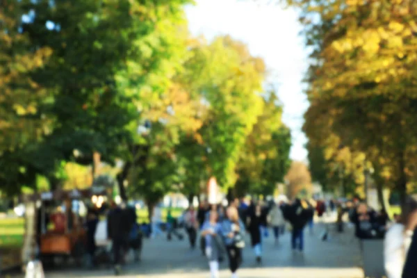 Stock image Blurred view of people walking in park on sunny day