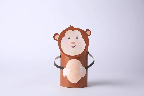 Toy monkey made from toilet paper hub on white background. Children\'s handmade ideas