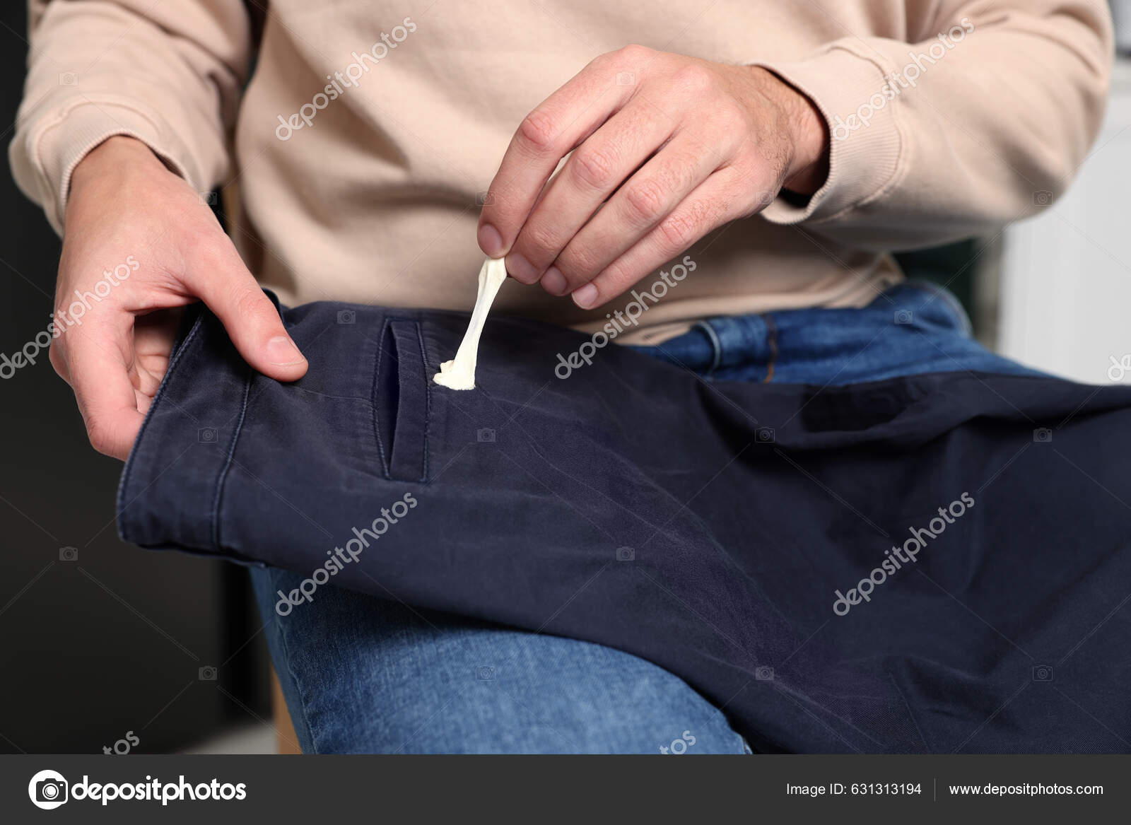 Man Removing Chewing Gum Black Jeans Closeup Stock Photo by ©NewAfrica  631313194