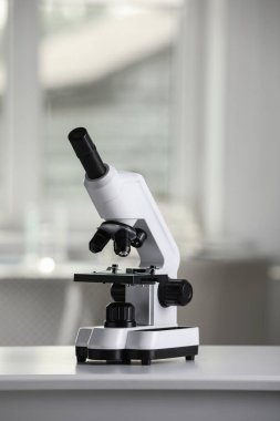 Modern medical microscope on white table in laboratory