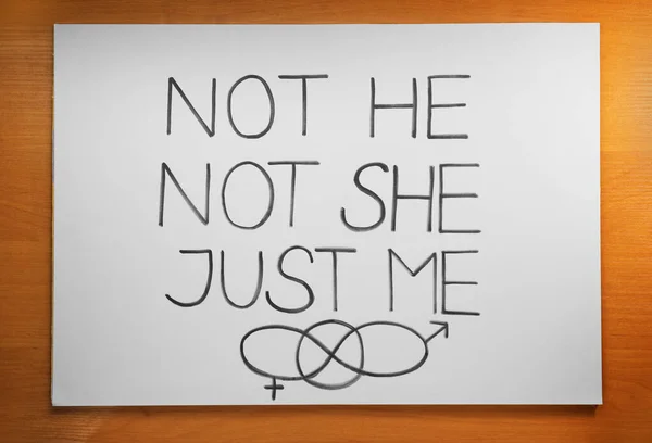 stock image Card with text Not He Not She Just Me and gender symbols on wooden background, top view