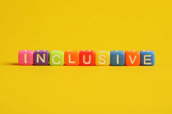 Colorful cubes with word Inclusive on yellow background
