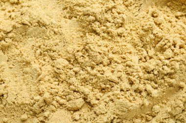 Aromatic mustard powder as background, top view
