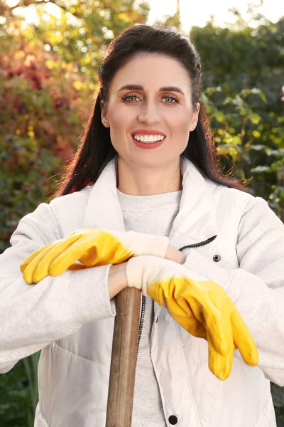 Woman wearing gloves and having rest after working in garden