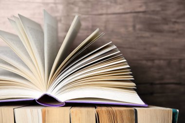 Ahşap arka plana karşı farklı kitaplar, yakın plan. Metin için boşluk