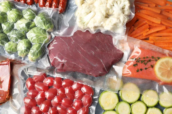 Many different food in vacuum packings as background, top view