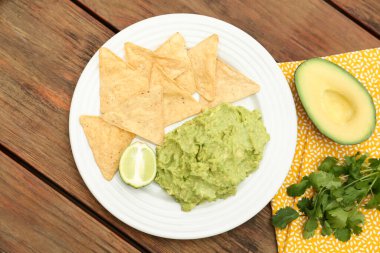Avokado, nachos ve limondan yapılmış nefis guacamole, ahşap masa, düz uzanma