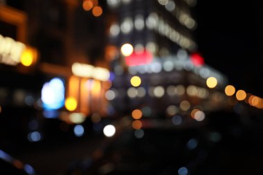 Gece ışıklarıyla şehir caddesinin bulanık görüntüsü. Bokeh etkisi