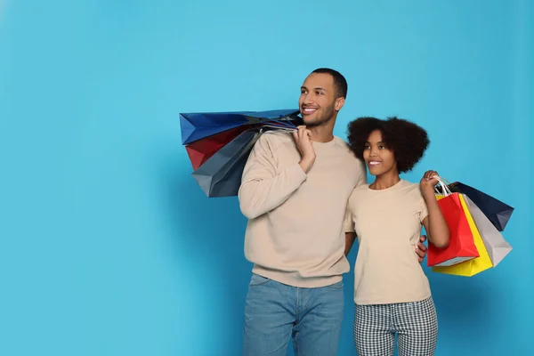 Happy African American Couple Shopping Bags Light Blue Background Space — Foto Stock