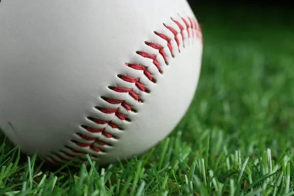 Baseball ball on green grass, closeup. Sports game