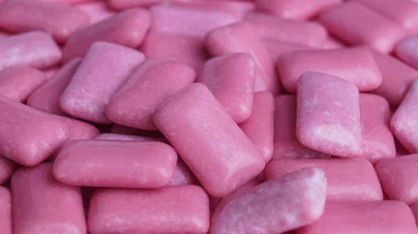 Many pink chewing gums as background, closeup