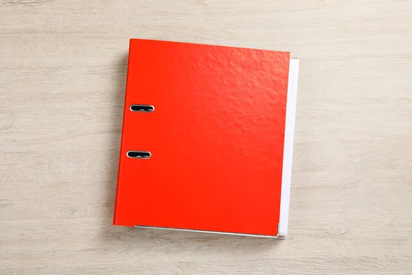 Orange office folder on white wooden table, top view